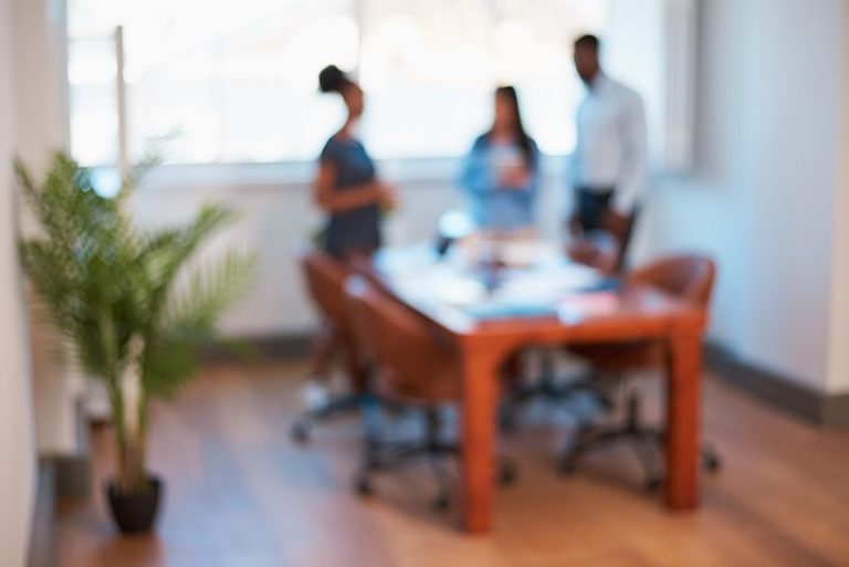 VistaCreate 638443376 stock photo blurred out focus office boardroom background three unidentified people high 768x513